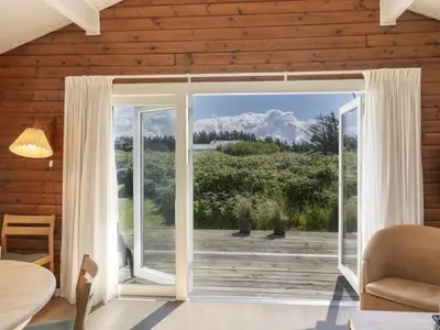 an open door into a living room with a patio at Holiday Home Efra - 400m from the sea by Interhome in Saltum