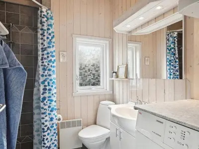 a bathroom with a toilet and a sink at Holiday Home Sigbritt - 2-6km from the sea by Interhome in Blokhus