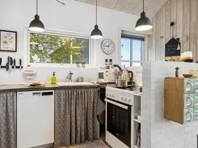 a kitchen with a stove and a sink at Holiday Home Benni - 75m to the fjord by Interhome in Løgstør
