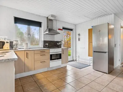a kitchen with a stainless steel refrigerator and cabinets at Holiday Home Patrik - 200m to the fjord by Interhome in Fur