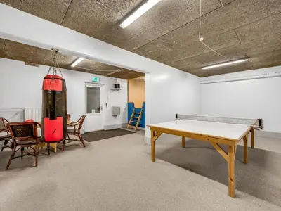 a room with a ping pong table and chairs at Apartment Alvy - 100m to the fjord by Interhome in Lemvig