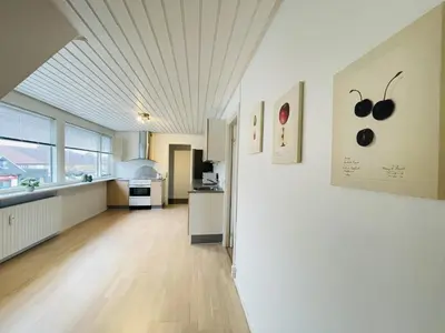 a large kitchen with white walls and wooden floors at aday - Modern 3 bedrooms apartment in Svenstrup in Svenstrup