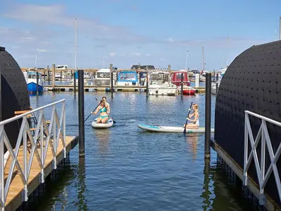 a group of people on kayaks in a marina at Boathouses dk - Besøg os direkte på hjemmesiden in Vinderup