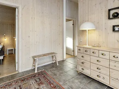 a room with a dresser and a table and a lamp at 7 person holiday home in Fjerritslev-By Traum in Fjerritslev