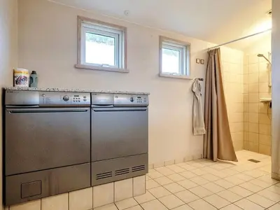 a kitchen with a stainless steel dishwasher in a bathroom at 4 star holiday home in Blokhus-By Traum in Blokhus