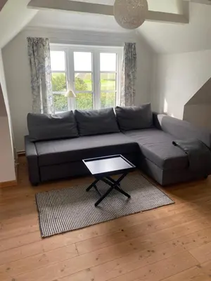 a living room with a couch and a table at Søbugten in Nykøbing Mors