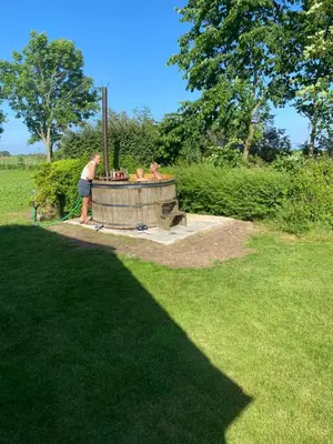 a man standing next to a picnic table in a field at Søbugten in Nykøbing Mors
