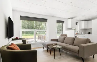 a living room with a couch and a table at 3 Bedroom Cozy Home In Farsø in Farsø
