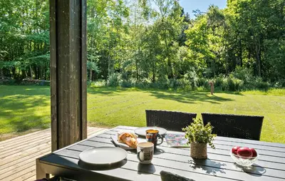 a table with a dog sitting on top of it at 3 Bedroom Cozy Home In Farsø in Farsø