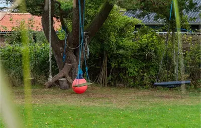 a red ball is hanging from a tree at Beautiful Home In Hurup Thy With Wifi in Doverodde