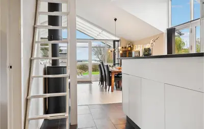 a kitchen with a ladder leading to a dining room at Beautiful Home In Hurup Thy With Wifi in Doverodde