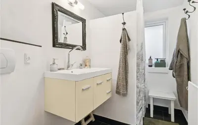 a white bathroom with a sink and a mirror at Beautiful Home In Hurup Thy With Wifi in Doverodde