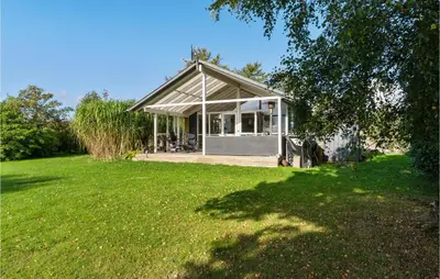 a small house in a field with a green yard at Beautiful Home In Hurup Thy With Wifi in Doverodde
