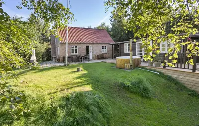 a backyard with a house and a yard with a wooden barrel at 3 Bedroom Amazing Home In Fur in Fur