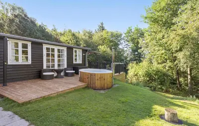 a backyard with a hot tub on a wooden deck at 3 Bedroom Amazing Home In Fur in Fur