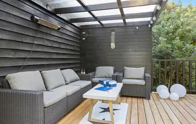 a patio with a couch and chairs on a wooden deck at 3 Bedroom Amazing Home In Fur in Fur