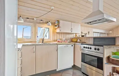 a kitchen with white appliances and a wooden ceiling at Amazing Home In Frøstrup With Sauna in Frøstrup