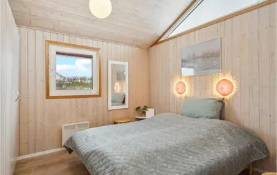 a bedroom with a bed and a window at Beautiful Home In Vinderup With Sauna in Vinderup