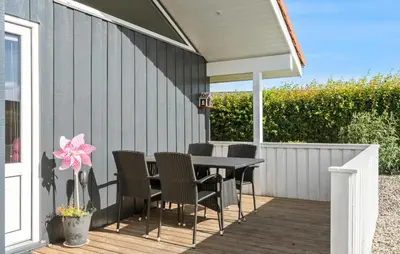 a patio with a table and chairs on a deck at Beautiful Home In Vinderup With Sauna in Vinderup