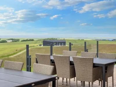 a table and chairs on a deck with a view at 5 star holiday home in Lemvig-By Traum in Lemvig