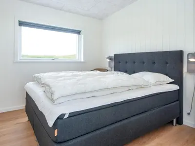 a large bed in a bedroom with a window at 5 star holiday home in Lemvig-By Traum in Lemvig