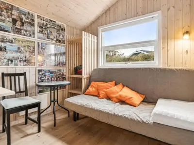 a living room with a couch and a window at Holiday Home Bruni - 400m from the sea by Interhome in Frøstrup