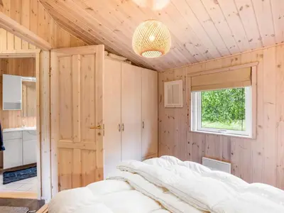 a bedroom with a bed and a window at Holiday Home Thrineke - 600m from the sea by Interhome in Saltum