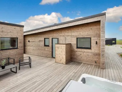 a building with a tub on a wooden deck at 5 star holiday home in Lemvig-By Traum in Lemvig