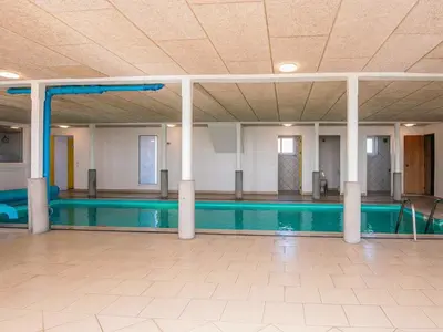 a large swimming pool in a building with columns at 20 person holiday home in Karby-By Traum in Karby