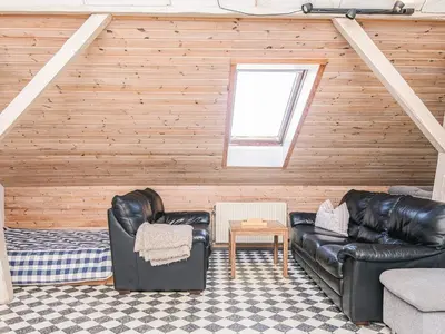 a living room with leather furniture and a window at 20 person holiday home in Karby-By Traum in Karby