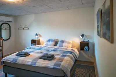 a bedroom with a bed with two towels on it at Cosy One in Struer