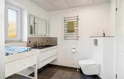 a white bathroom with a sink and a toilet at Nice Home In Roslev With Wifi in Roslev