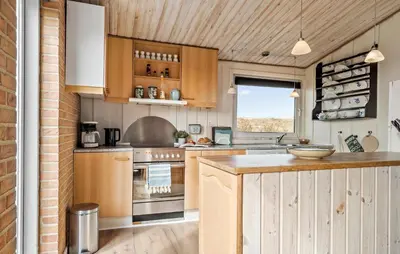a kitchen with wooden cabinets and a counter top at Awesome Home In Harboøre With Wifi in Harboør