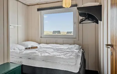 a bed in a small room with a window at Awesome Home In Harboøre With Wifi in Harboør