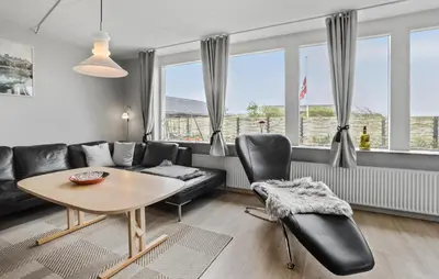 a living room with a couch and a table and chairs at Lovely Home In Vestervig With Wifi in Vestervig