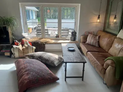 a living room with a couch and a table at The Fishermen's House - charming and close to beach in Vang