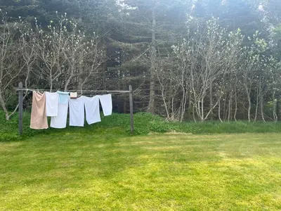 a clothes line with towels hanging in a field at The Fishermen's House - charming and close to beach in Vang