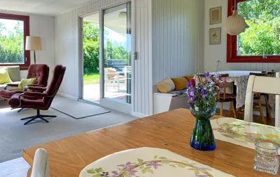 a living room with a table with a vase of flowers at 3 Bedroom Gorgeous Home In Vinderup in Vinderup