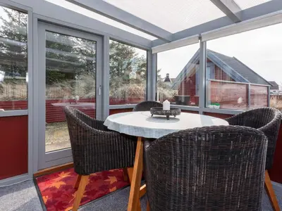a screened in porch with a table and chairs at 6 person holiday home in Thisted-By Traum in Thisted
