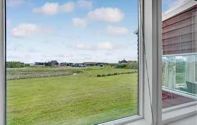 a window with a view of a field at Holiday Home Vinderup 5 in Vinderup