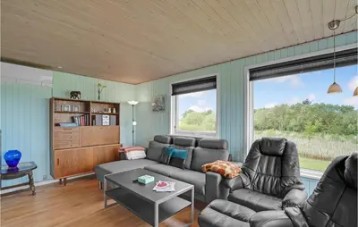 a living room with a couch and a table at Holiday Home Vinderup 5 in Vinderup