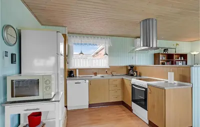 a kitchen with a white refrigerator and a microwave at Holiday Home Vinderup 5 in Vinderup