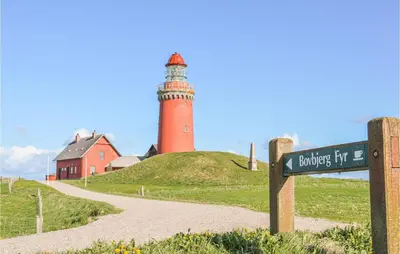 a lighthouse on top of a hill with a street sign at Holiday Home Lemvig 12 in Lemvig