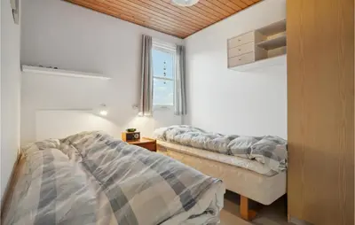 a bedroom with two beds and a window at Pet Friendly Apartment In Vestervig in Vestervig
