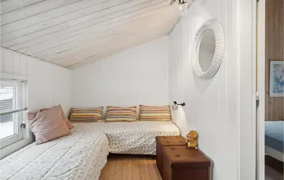 a white bedroom with a bed and a suitcase at Awesome Home In Saltum With Kitchen in Saltum