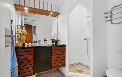 a bathroom with a sink and a mirror at Awesome Home In Saltum With Kitchen in Saltum