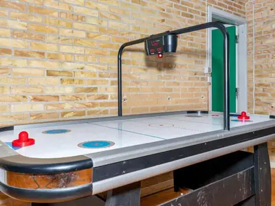 a ping pong table in front of a brick wall at 12 person holiday home in Roslev-By Traum in Roslev
