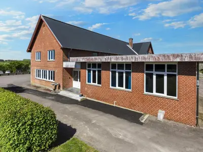 a red brick building with a black roof at 12 person holiday home in Roslev-By Traum in Roslev
