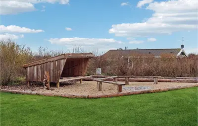 a park with a wooden structure in a grass field at Cozy Home In Vestervig With Sauna in Vestervig
