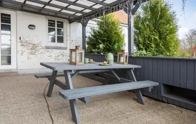 a picnic table and bench in front of a house at 5 Bedroom Gorgeous Home In Thyholm in Thyholm